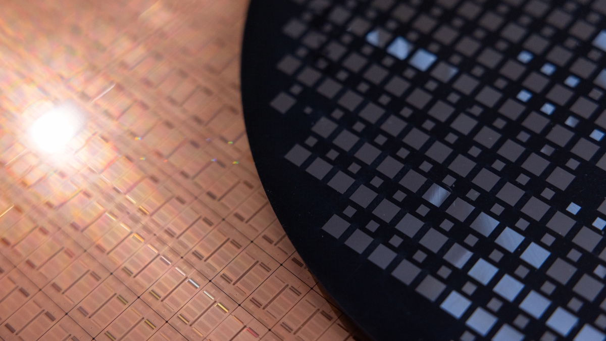 A closeup of a silicon wafer next to a molded wafer.
